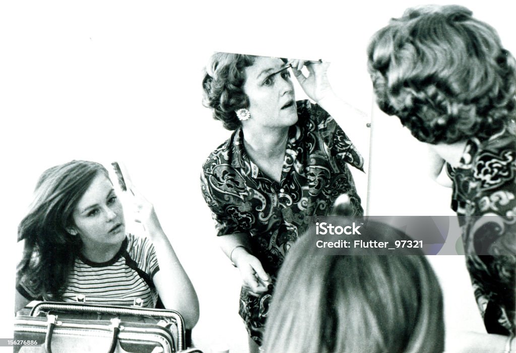 Mother and Daughter Putting on Make-up in Mirror, Vintage  Make-Up Stock Photo