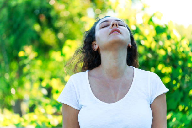 istock Young woman sweating on a hot summer day taking a deep breath while looking at the sky 1562769110