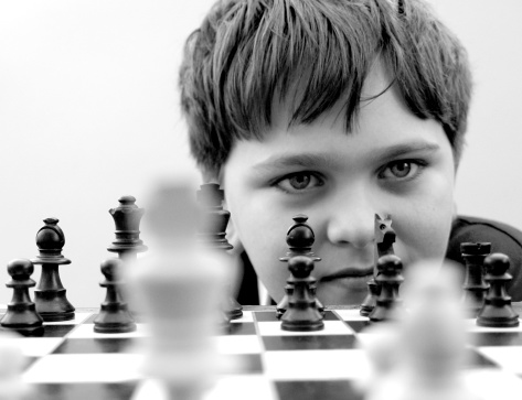 A Boy playing chess.