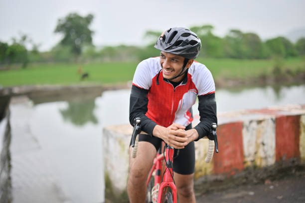istock Portrait of an active cyclist with his bicycle, wearing protective gear 1562774983