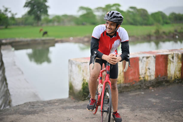istock Portrait of an active cyclist with his bicycle, wearing protective gear 1562775508