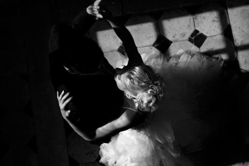 Married couple dancing the waltz in black and white.