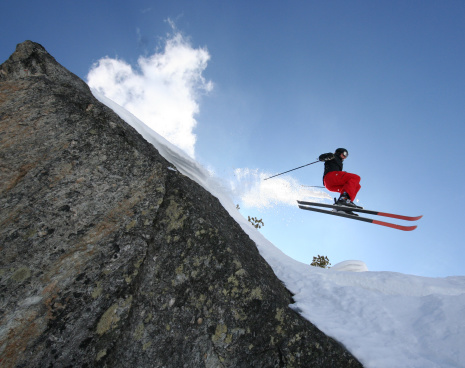 Skier jumping off a cliff.