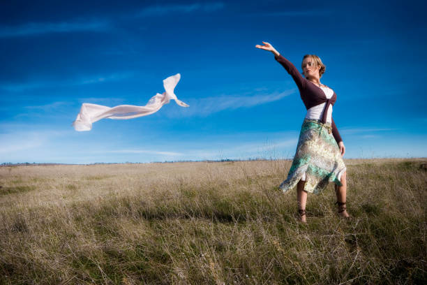 Portrait of a blond curly woman at sunset holding her hair