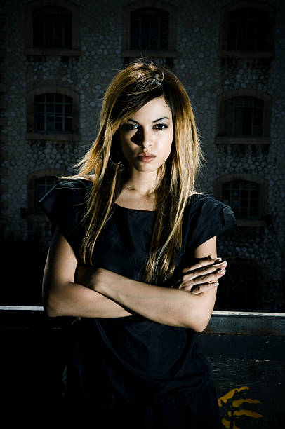 Portrait of the young beautiful girl near stone wall