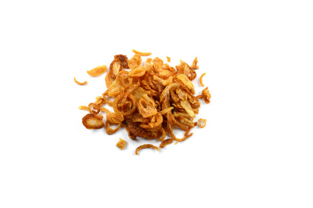 istock Deep fried shallots for garnishing over white background 1562782424