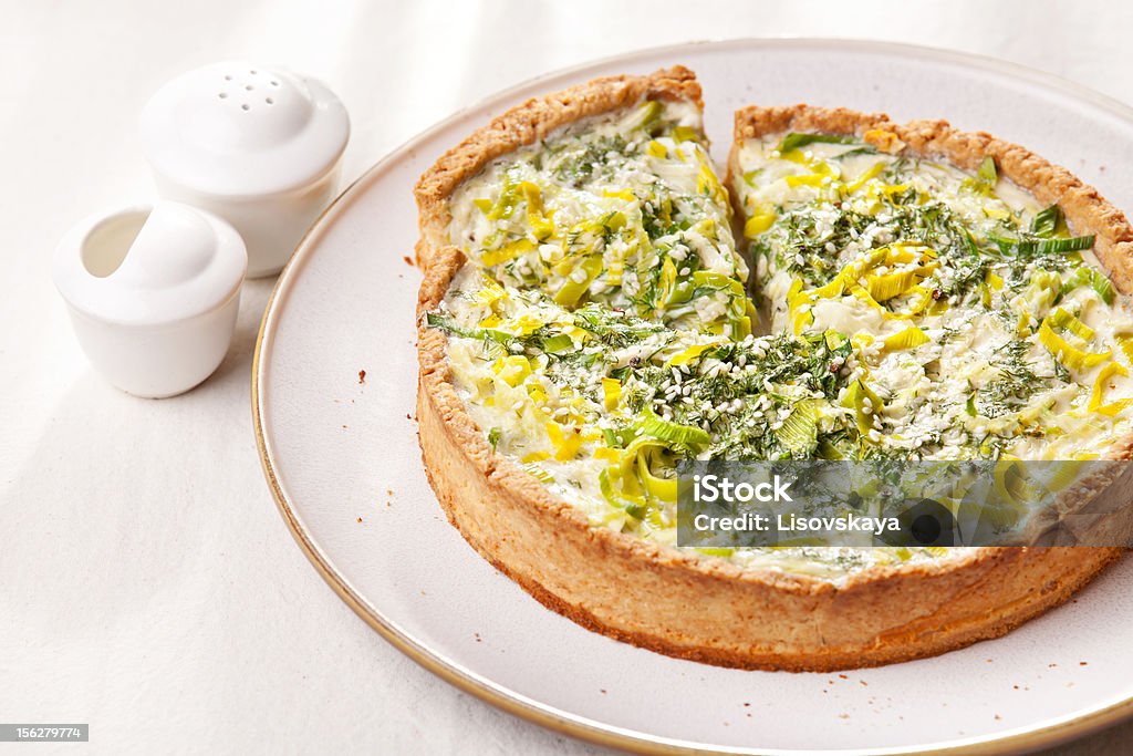 Leek quiche Leek quiche on white textured background Leek - Vegetable Stock Photo