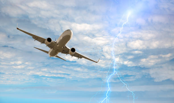 istock Airplane in the sky with thunder and lightning 1562804822