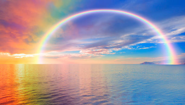 istock Beautiful landscape with turquoise sea with double sided rainbow at sunset 1562807433