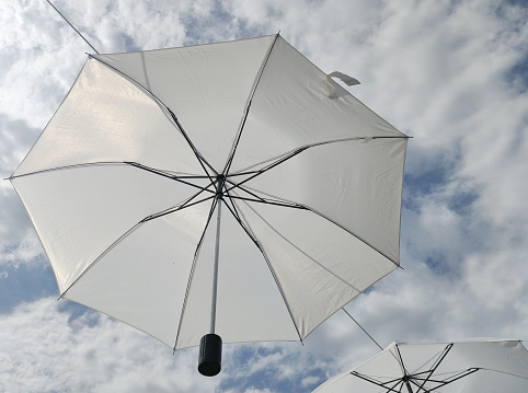 Open umbrella and the sky in the background