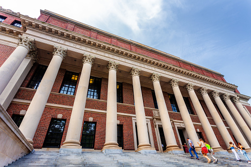 Cambridge, Massachusetts, USA - July 11, 2023: People on the steps of the Harry Elkins Widener Memorial Library building. The Widener Memorial Library, housing some 3.5 million books in its stacks, is the center­piece of the Harvard College Libraries.