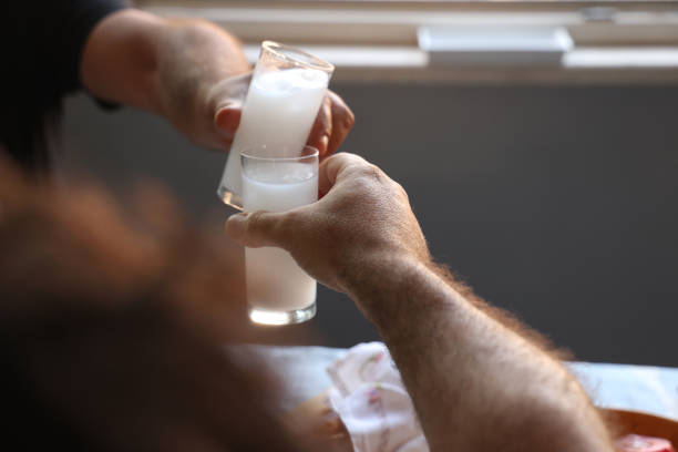 istock Friends Drinking Raki or Ouzo at a Delicious Table 1562845346
