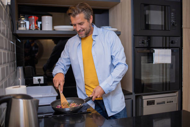 istock Man cooking food 1562845885