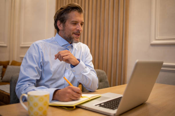 istock Mid adult man working from home 1562851334