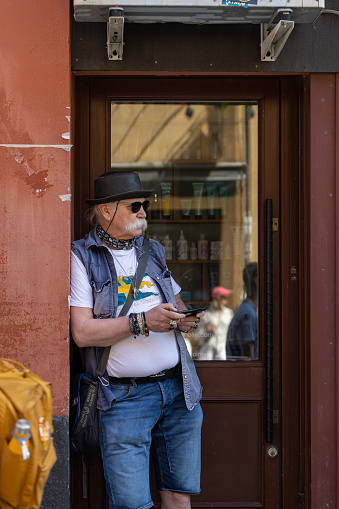 Stockholm, Sweden June 24, 2023 A male onlooker in a doorway watches a reenactment parade  to commemorate 500 years since King Gustav Wasa took Stockholm in 1523 to create the nation of Sweden.