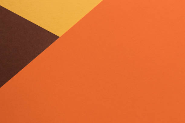 istock Orange and brown paper lies on the table, creating a geometric composition 1562875775