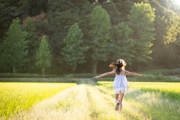A girl running on a footpath at dusk