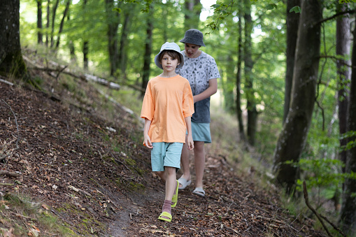 Only Two Teenagers Boys walking in the forest. Poland.