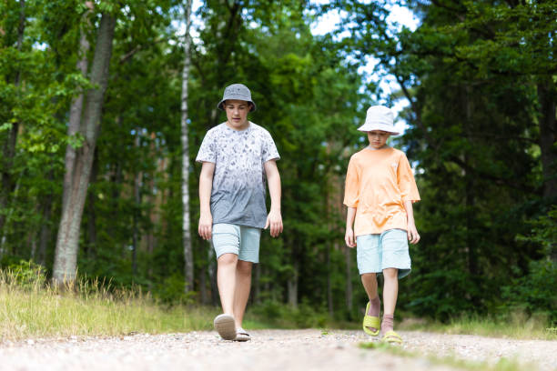 istock Young Boys walking in the forest 1562897580