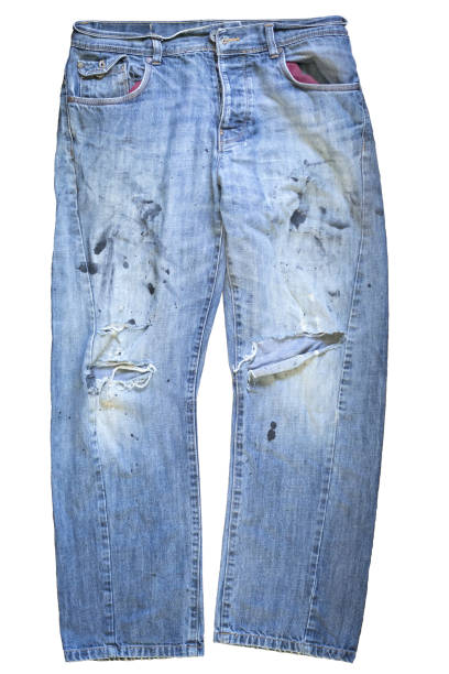 Old blue jeans with rips and paint stains