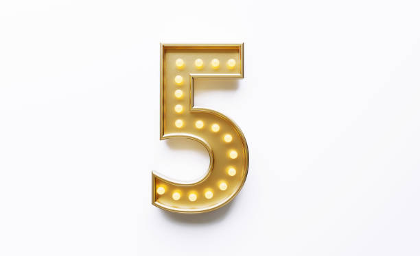 istock Gold Colored Number 5 Illuminated By Light Bulbs on White Background 1562966436