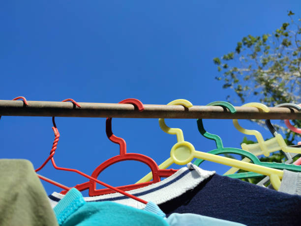 istock Clothes hanging on hangers on a sunny day 1562971359