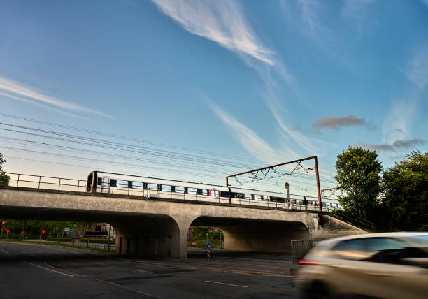 istock Passenger train crossing road on railway bridge 1562973507