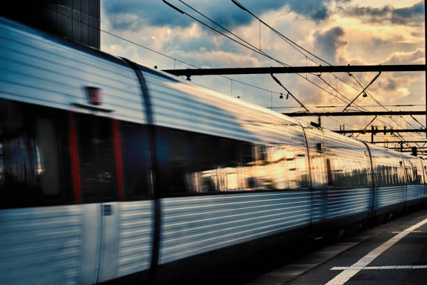 istock Train arriving at station at dusk 1562974093