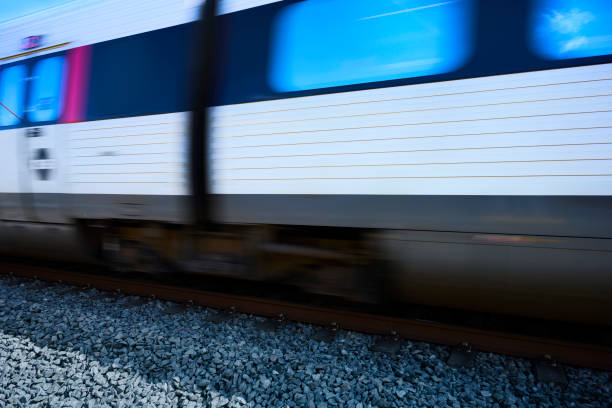 Gray passenger train passing by in high speed