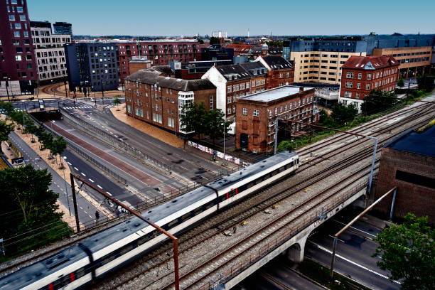 istock Passenger train crossing road on railway bridge 1562974284