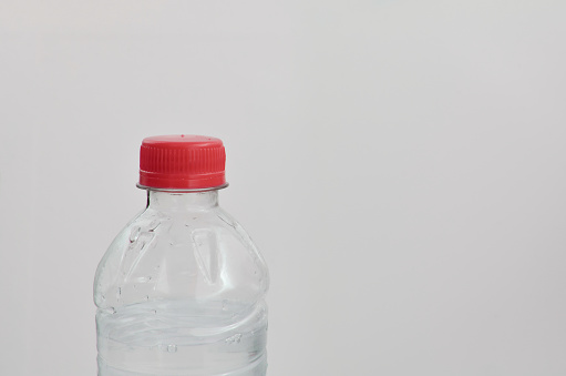Close-up of pet drinking water bottle, emphasizing the need for conscious consumption to ensure proper hydration and environmental sustainability.