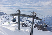 Cable car cabins rises up from Rosa Khutor at Sochi, Russia