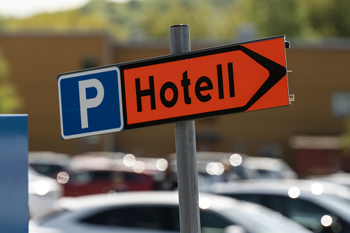 Hotel parking sign by a parking lot.