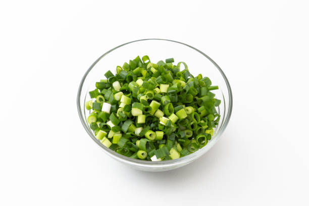 istock Chopped green onions on a white background. 1562975750