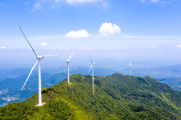 istock High mountains, sea of clouds and wind turbines 1562980456