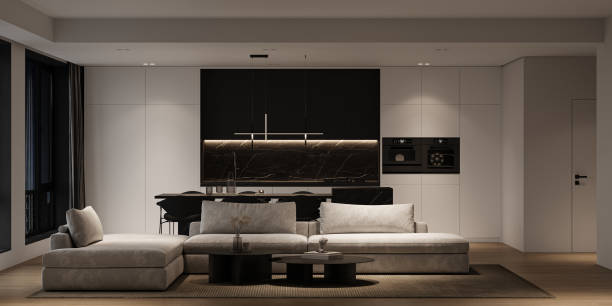 istock Modern minimalist interior livingroom with large modular sofa, panoramic windows and marble kitchen island. Front view night lighting. 3d rendering. High quality 3d illustration 1562980576