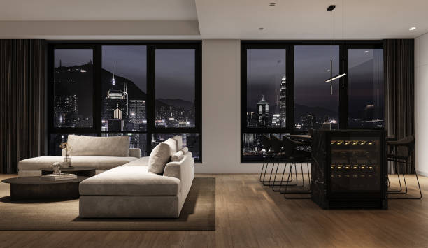 istock Modern grey minimalist interior livingroom with large modular sofa, panoramic windows, night city view and marble kitchen island. 3d rendering. High quality 3d illustration 1562980592
