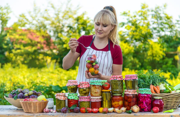 Woman with jar preserved vegetables for winter. Selective focus.