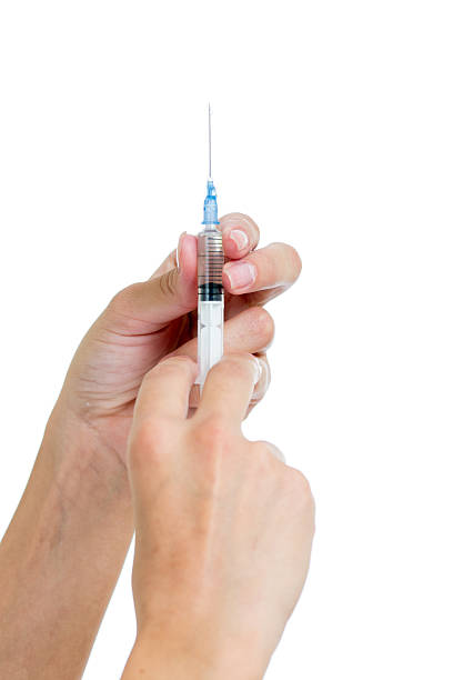 istock Syringe with a medicine in  female hands isolated 156300272