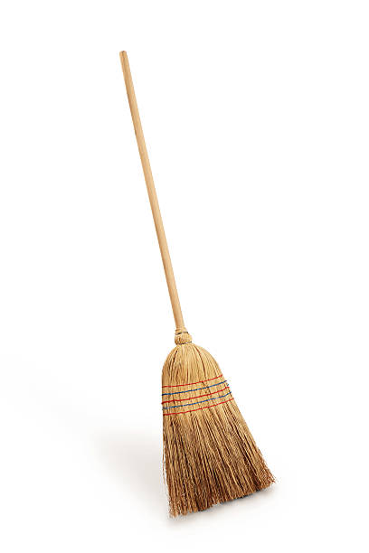 Straw broomstick against white background Straw broomstick on white background sweeping photos stock pictures, royalty-free photos & images