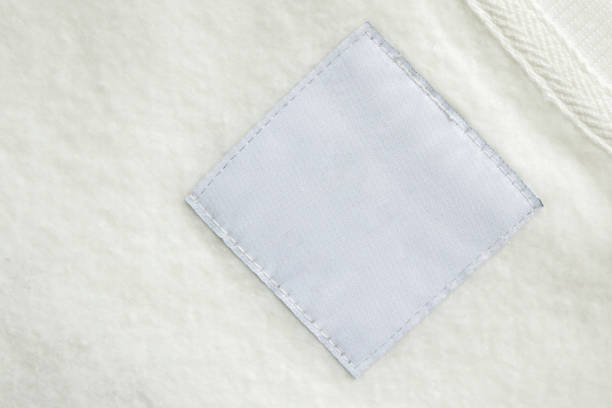 istock Blank white laundry care clothes label on fabric texture background 1563007537