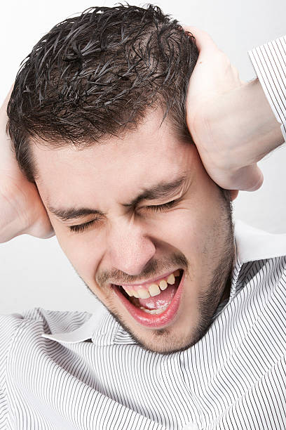 istock Man screaming and covering his ears 156300816