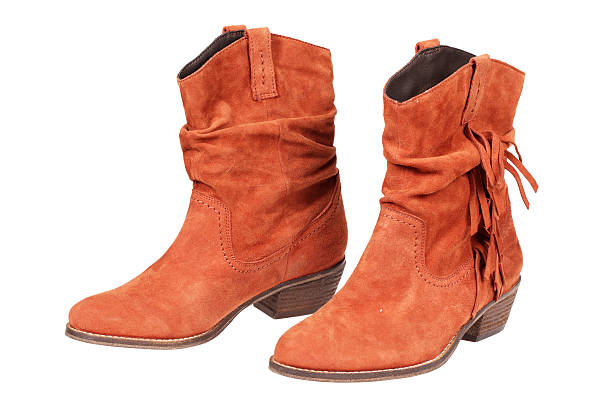 istock Orange woman's cowboy boots in white background 156301049