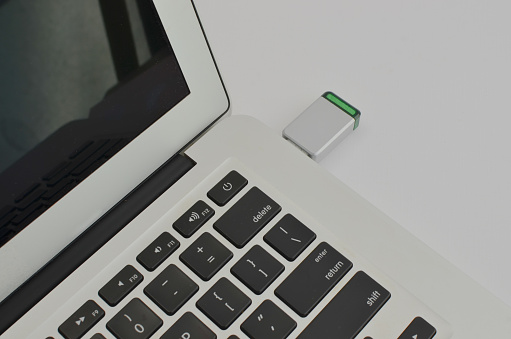Featured technology concept: USB stick inserted into the laptop, an efficient and functional combination.