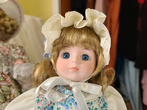 A closeup of the face on a china doll.