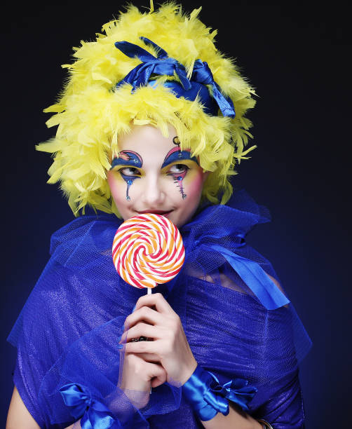 istock Girl with with creative make-up holds lollipop 1563030660
