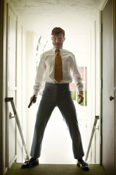 istock Retro Secret Agent Posing with Pistol 156303372