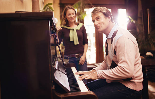 istock couple playing the piano 156304179