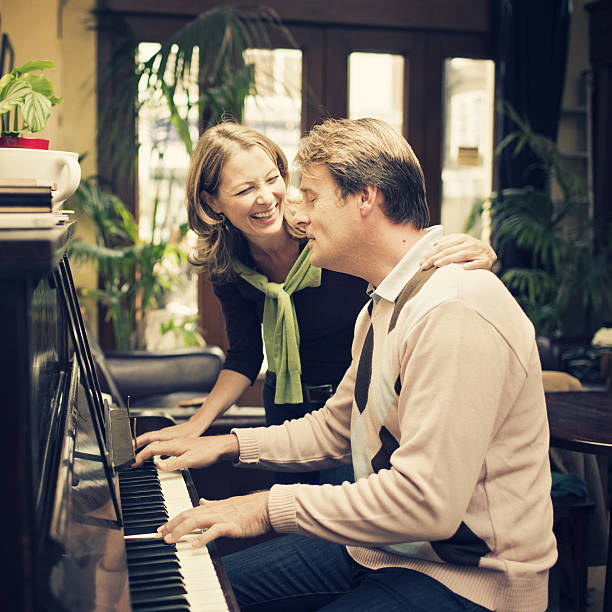 istock couple playing the piano 156304195