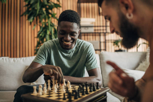 istock Male friends playing chess 1563076482